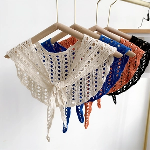 Close-up of crochet hollow knit shawls with intricate patterns in multiple colors