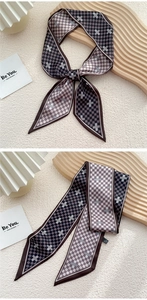 Détail macro du foulard twilly en soie à carreaux noué en ruban et plié pour les sacs