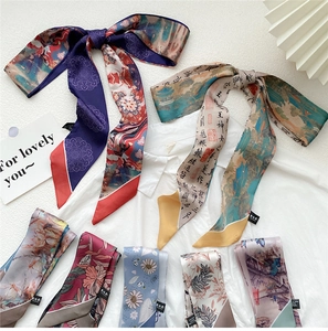 Detailed display of assorted oil painting style skinny silk scarves on a white shirt