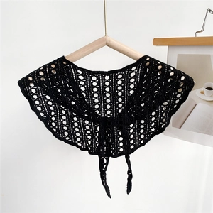 Detail of black hollow crochet shawl featuring delicate polka dot patterns and tie front