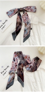 Dual-sided oil painting silk twilly scarf shown styled as a bow on a white shirt collar