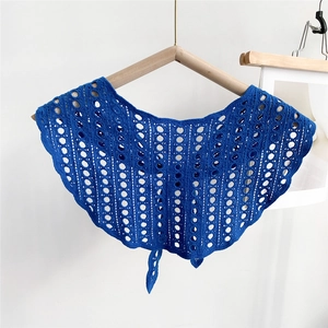 Detail of royal blue hollowed crochet shawl wrap with geometric knit patterns