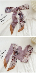 Detail of artistic oil painting silk twilly scarf used as an elegant neck tie decoration
