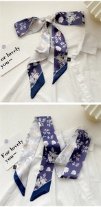 Close-up of a dark blue floral print silk twilly scarf styled on a white shirt