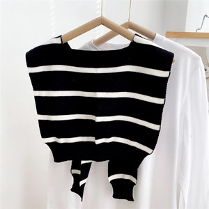 Detail of striped knitted shawl wrap with classic black and white horizontal pattern