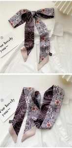Detail of oil painting floral silk twilly tied as a bow on a white textured background