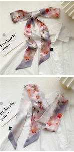 Detail of 100% silk twilly scarf with pink floral prints tied on white shirt collar