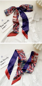 Detail of artistic oil painting silk scarf tied on a white shirt with ethnic floral patterns