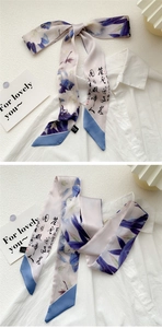 Detailed close-up of oil painting silk scarf with blue flowers and calligraphy on a shirt