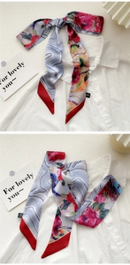 Detail of oil painting floral silk scarf styled on a shirt collar and draping naturally