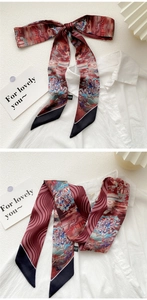 Detail of artistic oil painting skinny silk scarf tied in a bow on white shirt collar