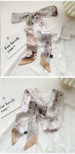 Detail of oil painting style silk scarf used as a bow knot on white shirt collar