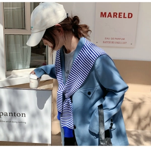 Blue blazer with a blue and white striped knit shawl accessory for a layered autumn look