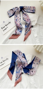 Artistic oil painting style skinny silk scarf tied as an elegant bow on a white shirt collar
