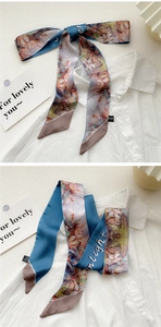Detail of 100% silk skinny scarf with floral print and D&D brand woven label