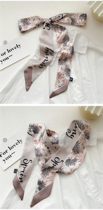 Detailed view of 100% silk twilly scarf tied on shirt with spring floral pattern