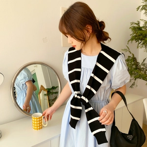 Blue puff sleeve dress paired with a black and white striped knit shawl accessory
