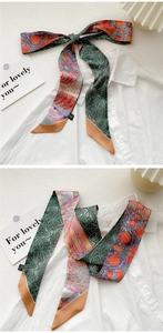 Detailed shot of artistic oil painting silk scarf tied as a decorative bow on a shirt