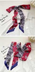 Detail of a 100% silk skinny scarf with oil painting floral patterns tied on a white shirt