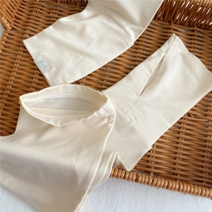 Women's cream white ice silk sun protection sleeves in a cozy woven tray display