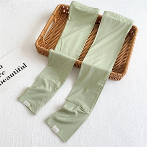 Close-up of light green ice silk sun protection sleeves on a woven decorative tray