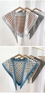 Detail of silk-texture triangle scarves with houndstooth and floral patterns on hangers