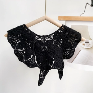 Close-up of black hollow crochet leaf pattern shawl with retro lace detail and tie closure