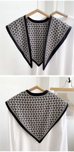 Detail of a black and white vintage decorative collar with radial pattern on a white shirt