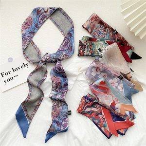 Artistic oil painting style narrow silk scarf used as a versatile headband or bag accessory