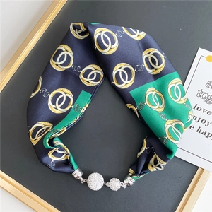Detail of silk scarf necklace with rhinestone spheres and magnetic metal buckle
