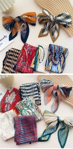 Flat lay of pleated silk neckerchiefs with various patterns and vibrant colors