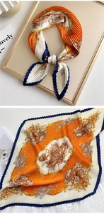 Detailed view of pleated silk scarf with vintage carriage pattern and accordion fold texture