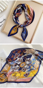 Detail of pleated silk scarf with vintage chain patterns in navy blue and yellow