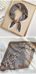 Detail showing pleated silk scarf with houndstooth print and gold chain pattern texture