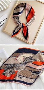 Detail of pleated silk scarf with vintage floral patterns and contrast stripe textures