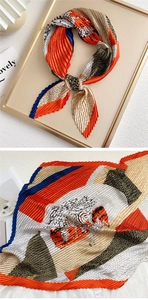 Detail of pleated silk scarf with animal print pattern and vibrant geometric color block
