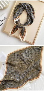 Detail of pleated silk scarf with vintage geometric patterns and accordion texture