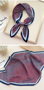 Detail of red white and blue pleated silk scarf with geometric pattern and zigzag edges