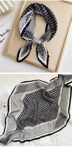 Detailed close-up of pleated silk scarf with houndstooth pattern and wavy edges