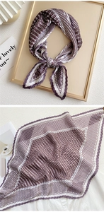 Detail of pleated silk scarf with brown and purple houndstooth pattern and wavy edges