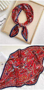 Detail of red pleated silk scarf with luxury vintage carriage print and gold accents