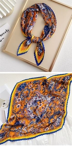 Detailed view of pleated silk scarf with artistic floral prints in vibrant blue and orange