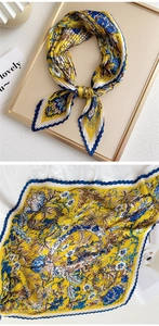 Detail of pleated vintage floral scarf in yellow and blue with zigzag stitched edges