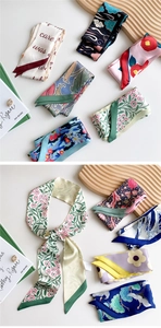 Close-up of long narrow silk scarves featuring vintage patterns and floral prints