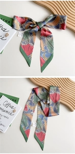 Detail of artistic floral silk scarf showing fabric texture and washing instructions tag