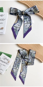 Detail of artistic owl and leaf print on a long silky twilly scarf tied as a bow