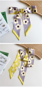 Detail of floral and polka dot silk scarf with smooth satin texture and elegant drape