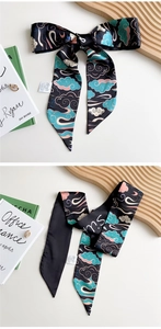 Detail of long silk scarf with traditional cloud pattern showing bow knot and drape