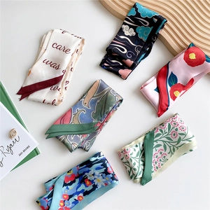 Selection of elegant narrow silk twilly scarves in various floral and artistic prints