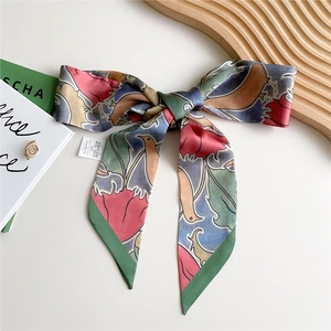Long printed polyester silk scarf styled as a bow with retro artistic pattern and wash label